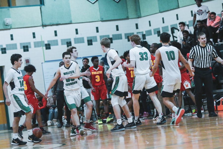 Walter Johnson varsity boys celebrate each other after the conclusion of their game against Wheaton High School.
