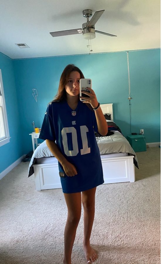 Junior Carly Dalton takes a selfie wearing her favorite football team's jersey. Dalton supports the Giants because it has been her favorite team every since she was born "I liked the Giants since I was born even though they are bad," Dalton said.