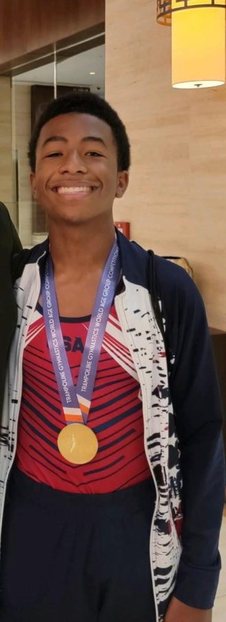 Talented gymnast and freshman Kai Lawson exhibits a gold medal around his neck. In November of last year, Lawson won gold for performing on the trampoline at the world championships.