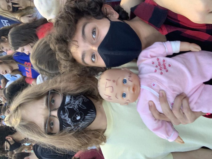 Friends and juniors Gonzalo Martinez and Philip Kutcher support the varsity football team in the bleachers. They were able to hold WJ Baby, an informal mascot that has made multiple appearances at football games.
"It was a fun experience holding the baby and taking a picture with it," Martinez said.