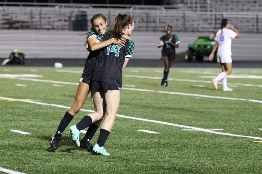 Teammates, friends and seniors Abby Calhoun and Emma Kothari celebrate after Calhoun scored her first goal of the season against Clarksburg High School. The goal was a memorable moment for Calhoun, as it was her last year on the WJ girls varsity soccer team.