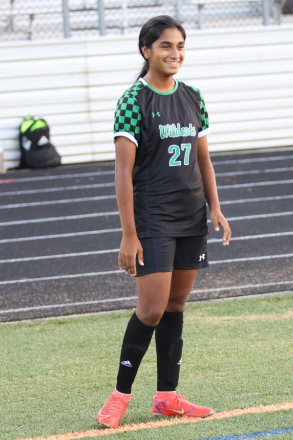 Freshman Maya Panicker exchanges a smile with her teammates before the game. Many consider Panicker as a player with incredible talent and potential.