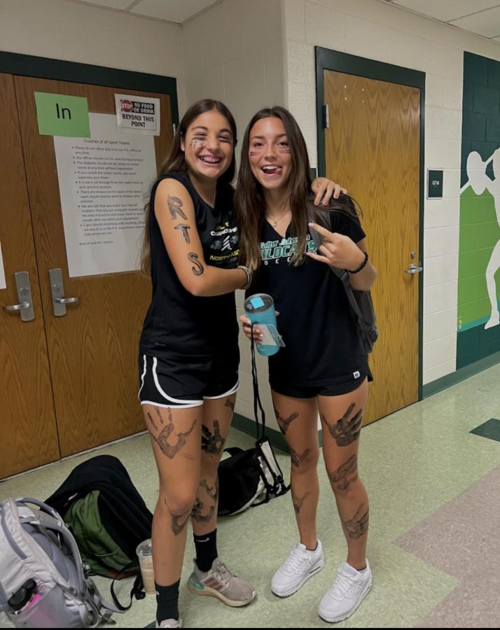 Junior Marina Thorn and sophomore Ella Hoban show their spirit before the varsity soccer game by wearing all black.