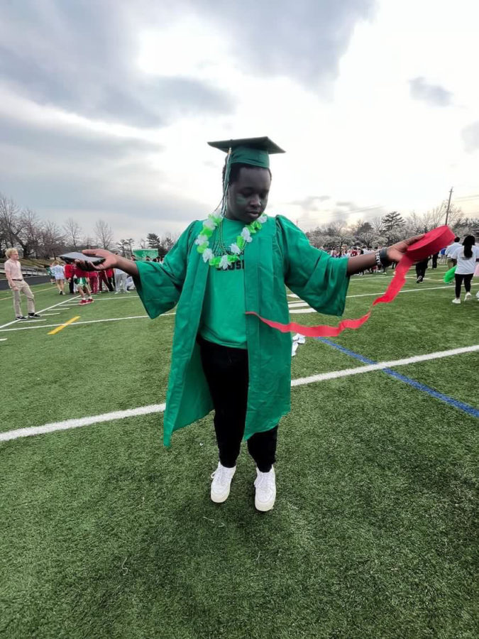 Senior SGA secretary Bryan Kibet    prepares for the pep rally by getting his costume ready and measuring the field for the games about to be played. "I had an amazing experience during the pep rally ! It was my eighth and final pep rally since I came to WJ freshman year and it was the best!" Kibet said.