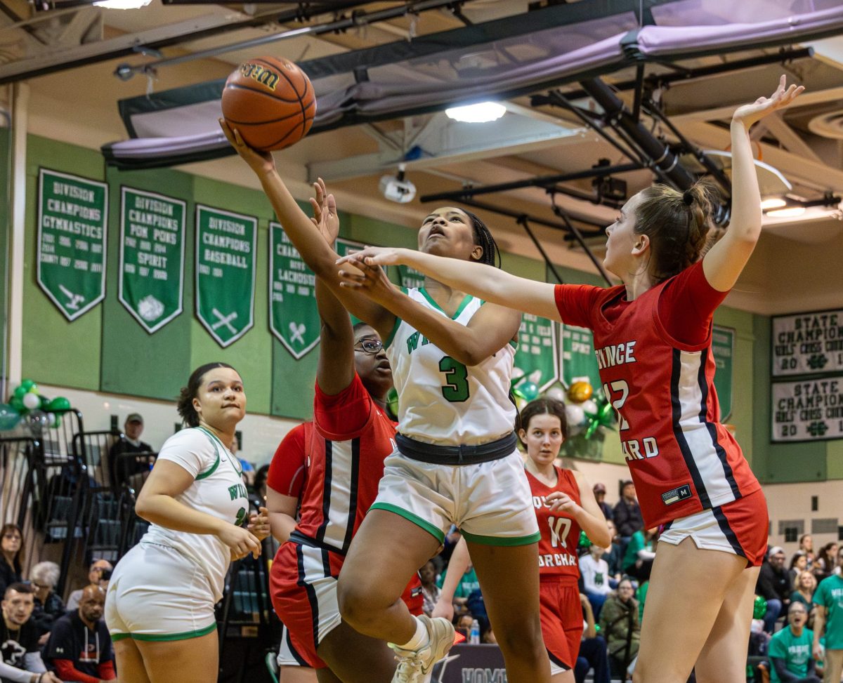 Senior Kendall Alexander goes up for a contested layup against the Quince Orchard Cougars. Alexander led the team in points last season and helped the Wildcats make it to the second round of the playoffs.