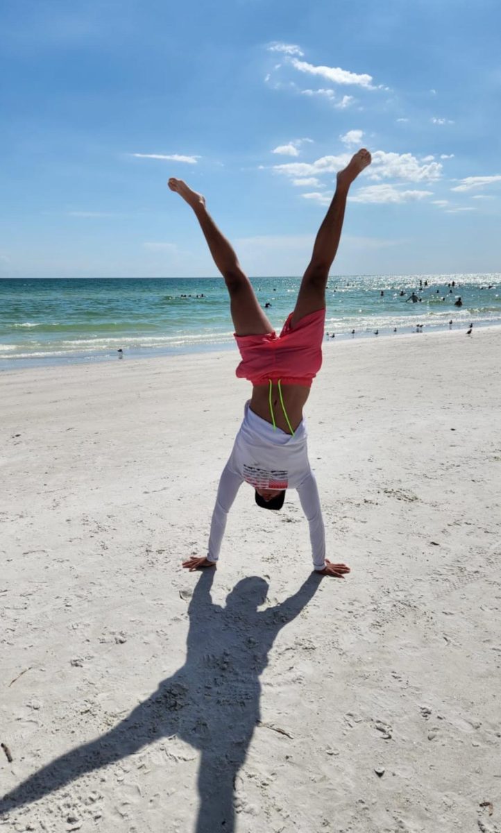 Sophomore Sebastian Hernandez does a handstand at the beach in Florida. (Courtesy Sebastian Hernandez)