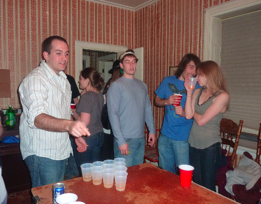 Teens play beer pong and continue drinking after reaching their limit. They had a party when their parents weren’t home and got in big trouble with their parents and the police for underage drinking.