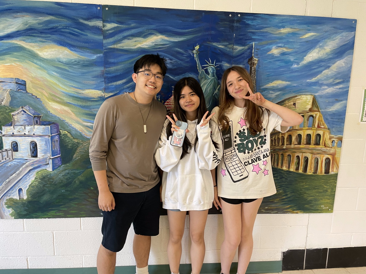 From left: Junior Honorary officer Skylar Zheng, junior Secretary Alexis Batac, junior President Sareen Papangelou. The officers of the Southeast Asian Union pose in front of a mural in the school. The club will join the school roster for the 2024-2025 school year, and all are welcome.