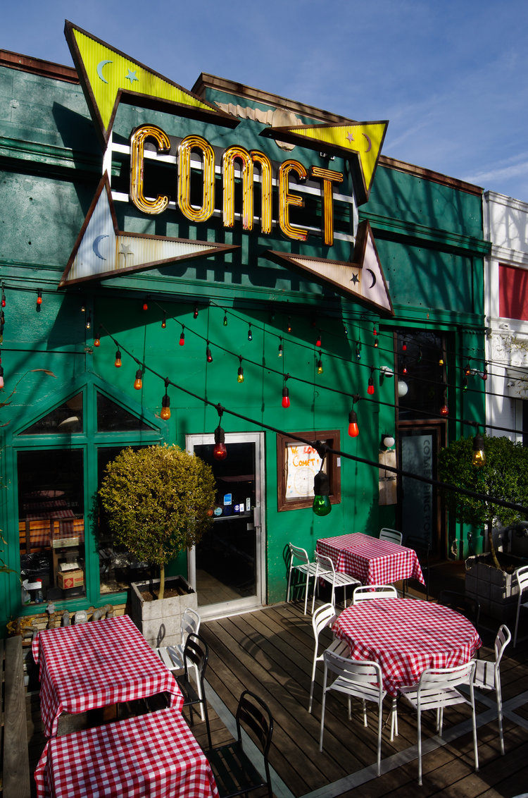 With colored light bulbs and checkered tablecloths, Comet Ping Pong provides indoor and outdoor seating, both with romantic atmospheres. (Courtesy Comet Ping Pong)