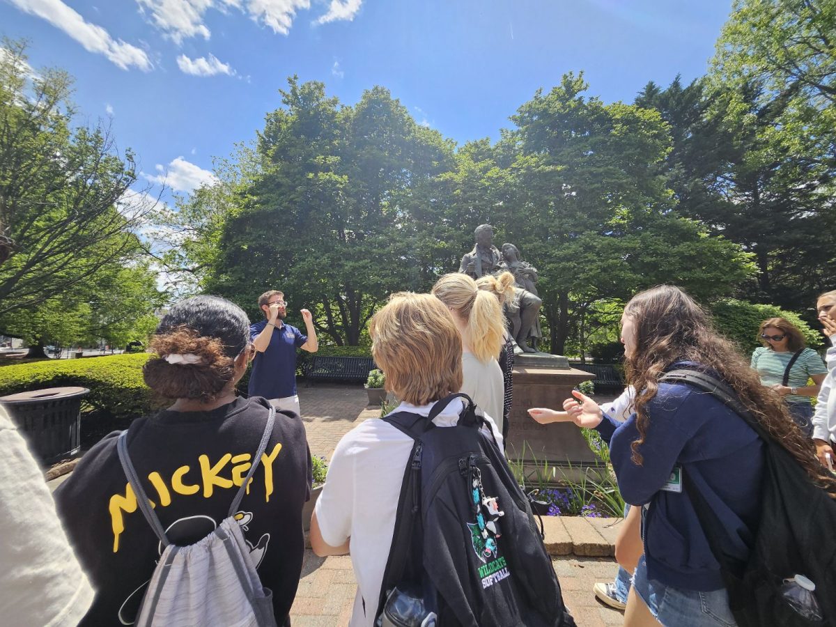 ASL 2 students on the Gallaudet field trip watch their tour guide explain the life of the university’s founder, Laurent Clerc, pictured in the statue to the guide’s left. The tour guide signed in ASL throughout the tour and an interpreter translated his signs into English.