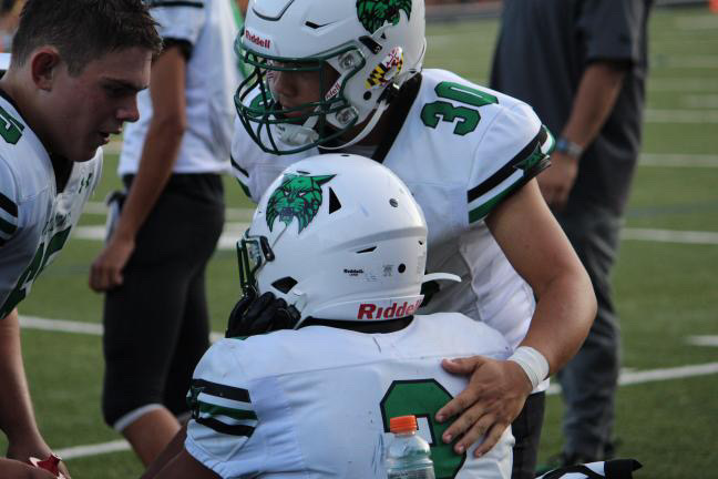 Junior Daniel Gershon gives a pep talk to Dylan Byrd during the B-CC game last year. Gershon and Byrd were great teammates last season but the star running back recently transferred to Whitman, and will be facing off against Gershon in the Thursday night game.