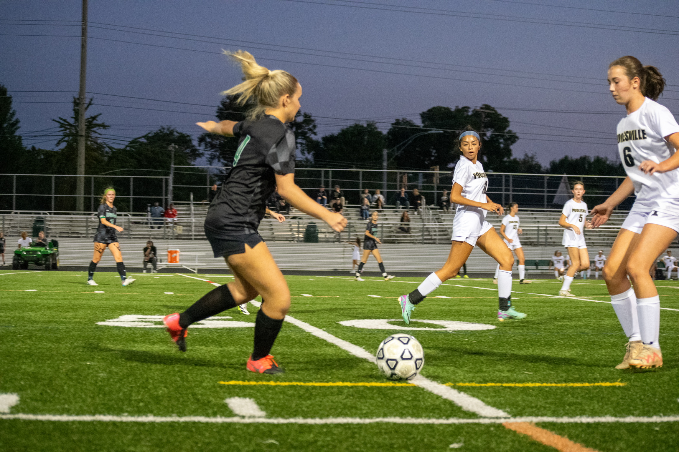 Senior Ginger Fishberg dribbles the ball into the attacking half, with junior captain Evie Avillo approaching behind her. (Courtesy Spencer Robinson)