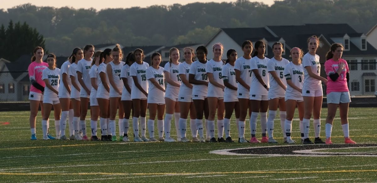 The girls soccer team lines up before the Oakdale game during the National Anthem. Oakdale ultimately had the upper hand, handing WJ it's first loss of the season. (Courtesy Merrie Gramlich)