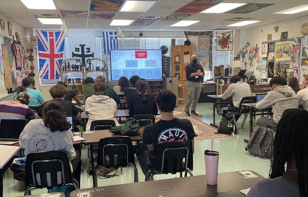 Social studies teacher Mitchell Joy lectures during his AP World History class last school year. While the school policy on students use of phones in class has not changed since last year, many teachers have increased their enforcement of the policy.