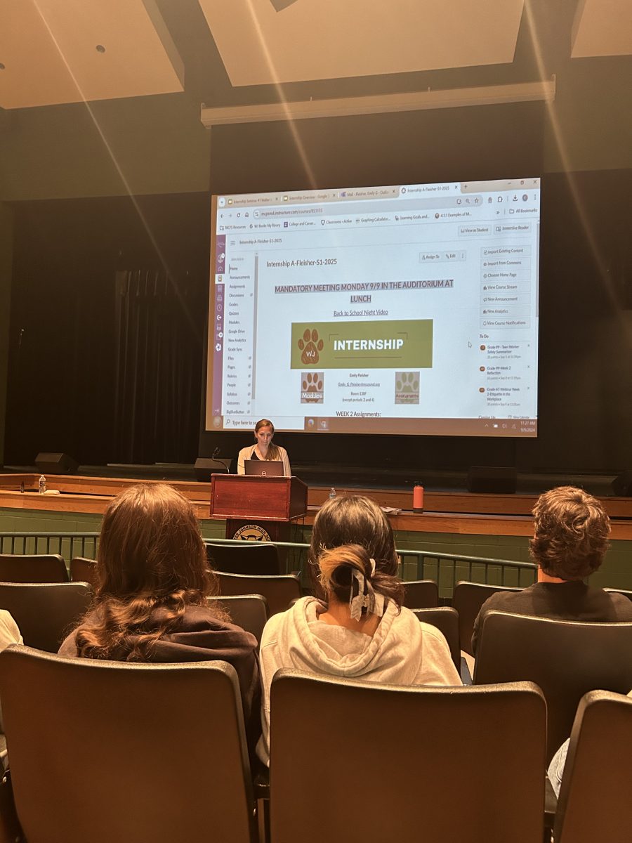 Internship coordinator Emily Fleisher leads an internship meeting in the auditorium. Check-ins like this are one of the ways Fleisher has added more structure and guidance to this program.