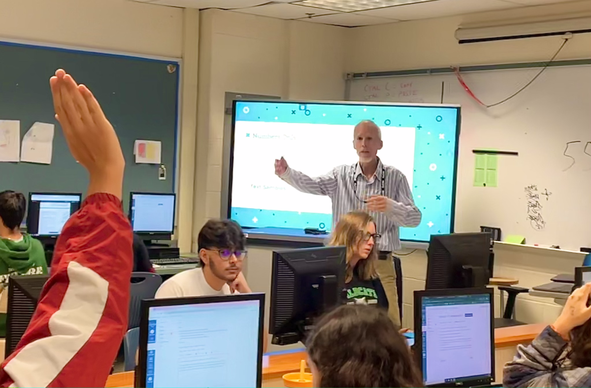 Computer science teacher Mike Livermore addresses a student's raised hand in the 4th period class on Sept. 9. This is Livermore's first year teaching at WJ. "I've taught adults and I've taught young ones, but I've never taught at a public school at any level, only small private schools," Livermore said.