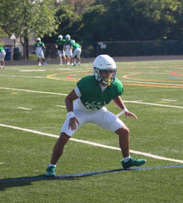 Junior John Laird warms up for their pre-season scrimmage against Magruder. "I enjoy warmups because it gets everyone hyped and ready to play," Laird said. (Courtesy Johnny Abrams)