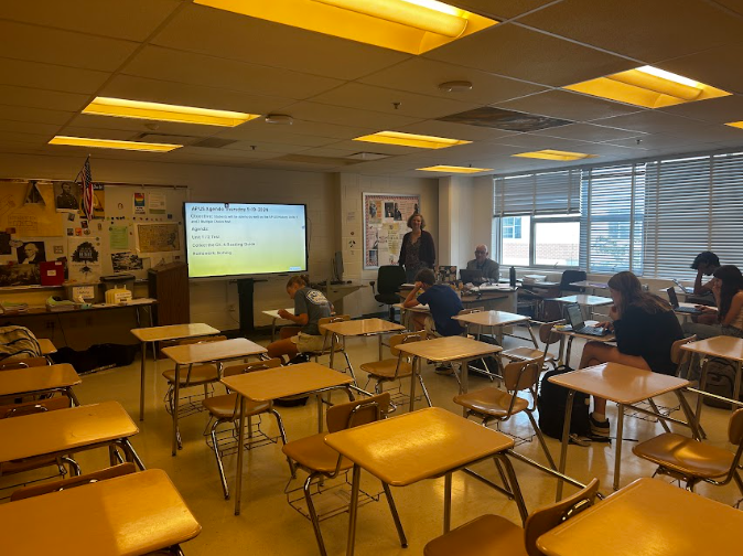 Teachers Katherine Simmons and Nathaniel Schwartz instruct during lunch in room 130. Both are co-directors of the APEX Reach Program and teach a variety of courses in the social studies field. The two have made necessary changes to the program with the increasing population of WJ students.