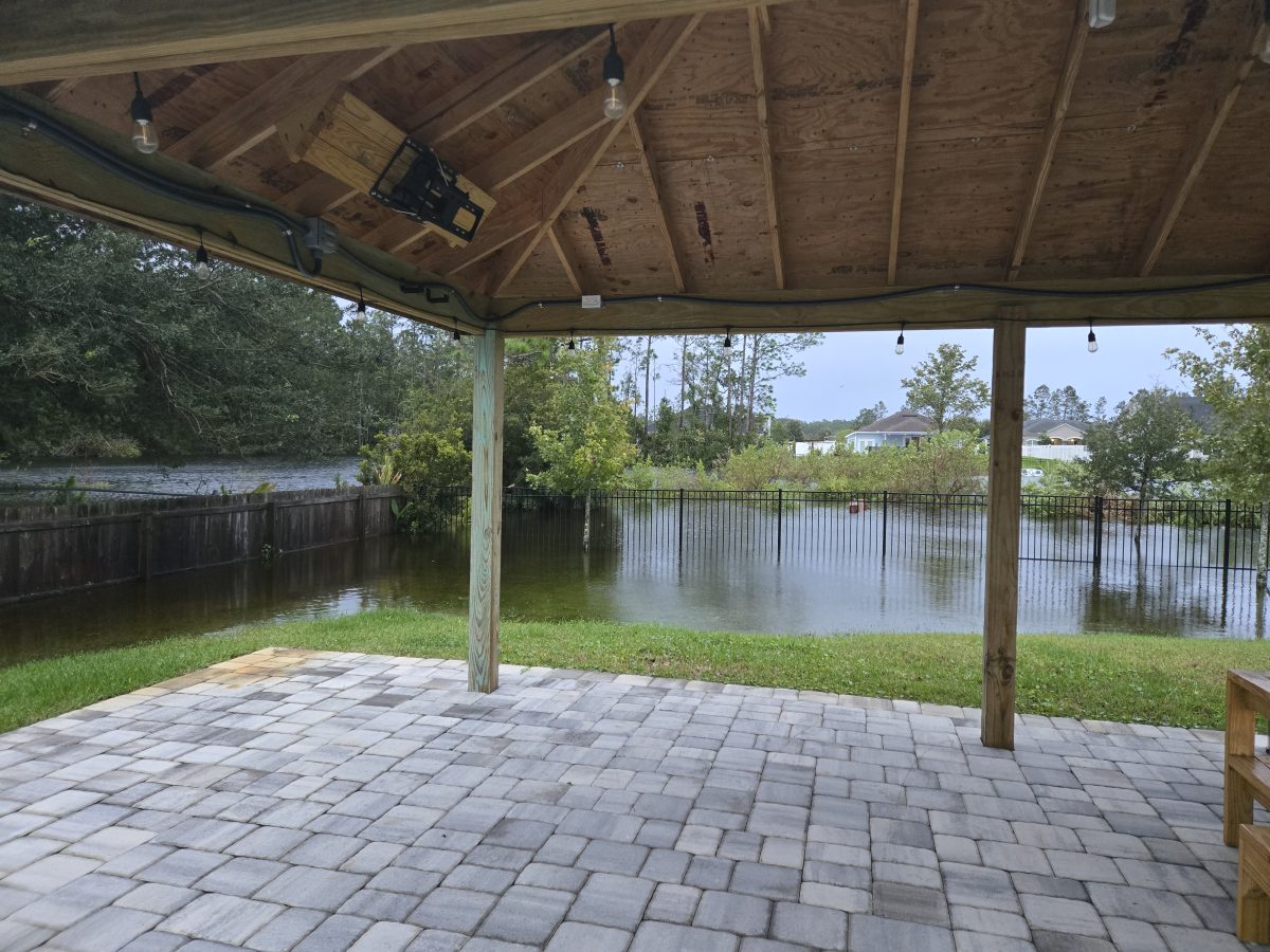 This New Smyrna Beach rental home, occupied by ASL teacher Kiara Campbell's friend, experienced flooding that overflowed the lake. "Usually her husband and kids can go on the outside of this [fence] and fish in that in that little pond and it almost hit where her pergola is," Campbell said. (Courtesy Kiara Campbell)