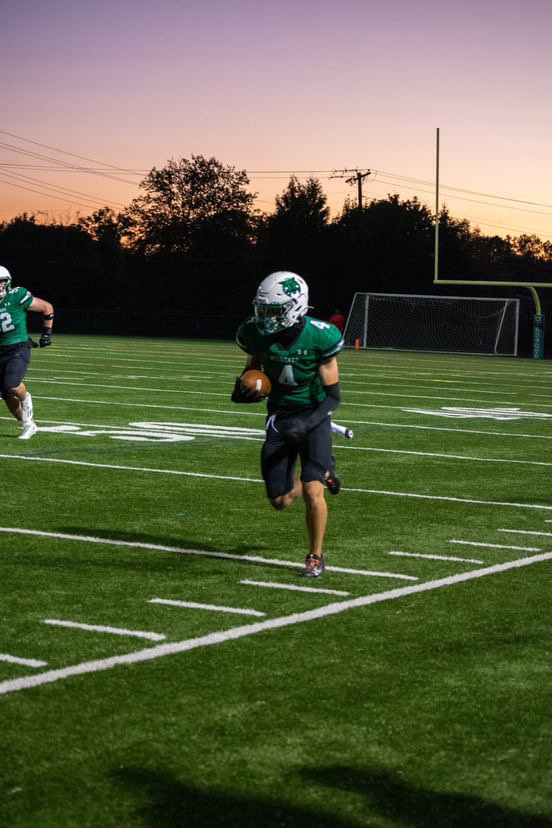 Senior WR Joshua Koenick runs with the ball in the homecoming game against Wheaton. Koenick was a major playmaker in the absence of wide receivers Devin Markert and Ryan Gardner as the Wildcats took down the Knights. (Courtesy Spencer Robinson)