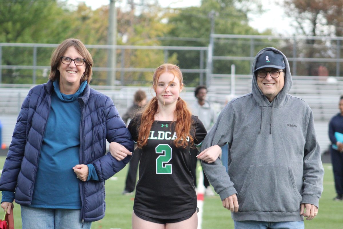 Senior captain and quarterback Ellie Weinstein walks with her parents for senior night. "I love this school. I love the people here. I think we bonded so much this year. I love celebrating. It's a beautiful school. It's a beautiful team. I love the people and the girls," Weinstein said.