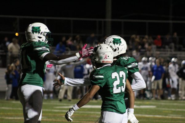 Junior Tauren Sirleaf celebrates with his teammates after scoring a touchdown. Although the Wildcats were able to get on the board, it wasn't enough as the Warriors trampled the Cats 47-19. "We didn't come out with the right attitude the whole game, " senior Lloyd Erim said. "Obviously Sherwood is a good team but we believe we're also a good team."