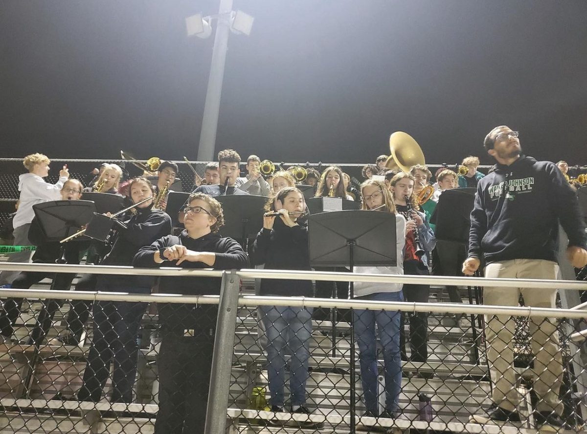 Pep Band plays a song at a home fall football game. "I think pep band is for people that want to go to football games a lot and maybe don't have people to go. It's a place to have fun with a lot of friends," pep band captain senior Theo Hansen said.