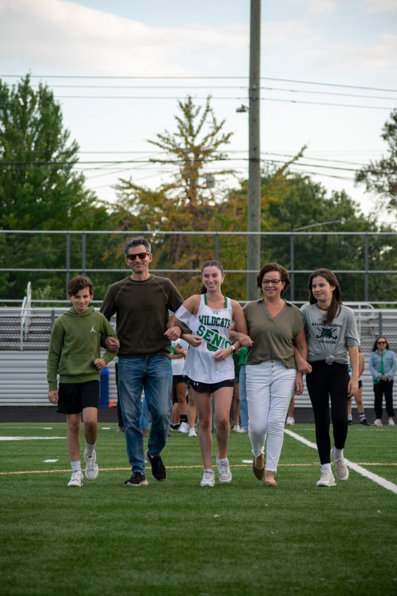 Senior Chloe Palan walks on senior night for the game against Clarksburg High School. Palan was accompanied by her brother, sister, mom and dad for her big night. (Courtesy Spencer Robinson)