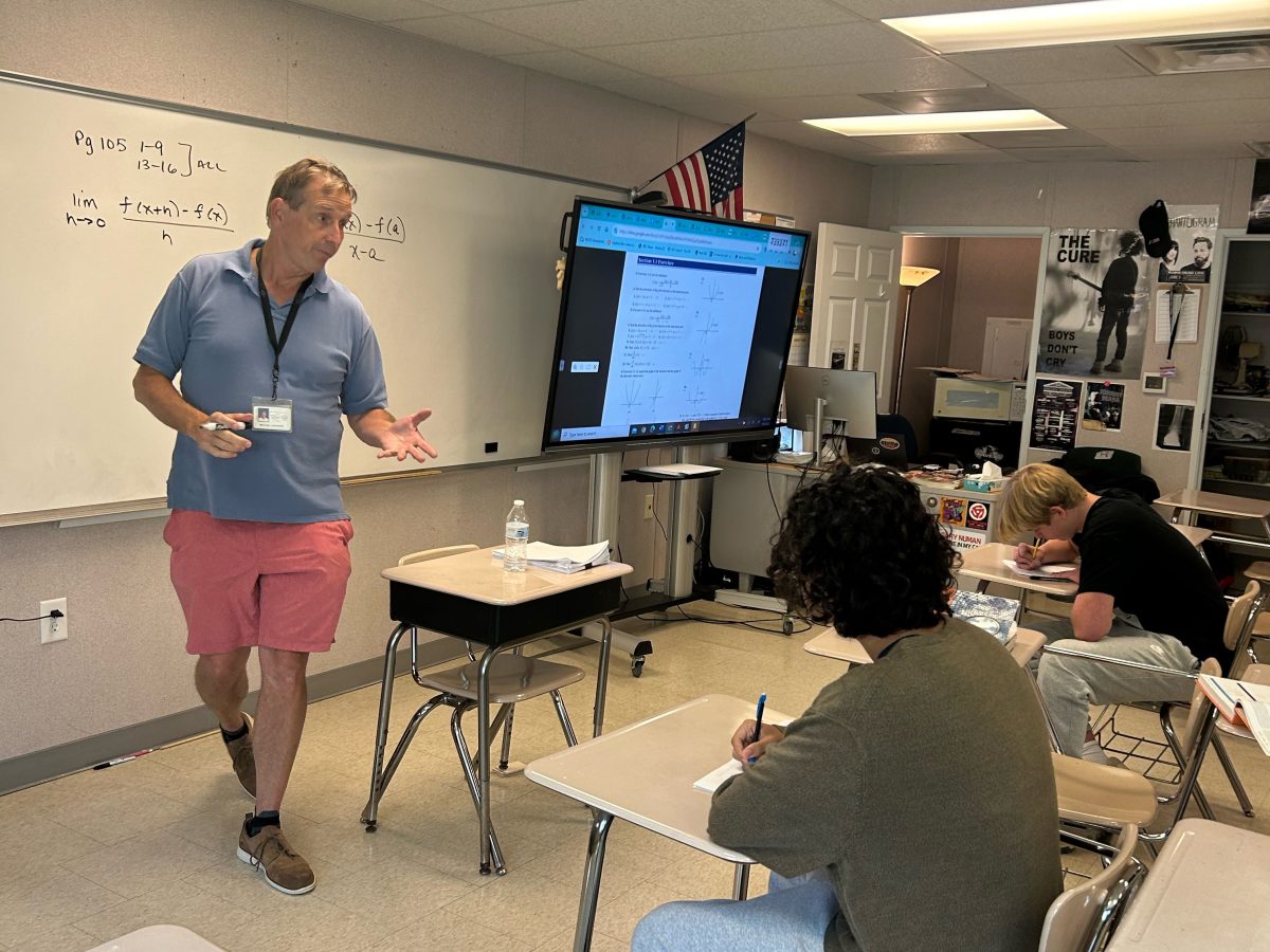 Michael Laukaitis explains a calculus concept to students during lunch. He has always made himself available for help outside of class, something many students appreciate.