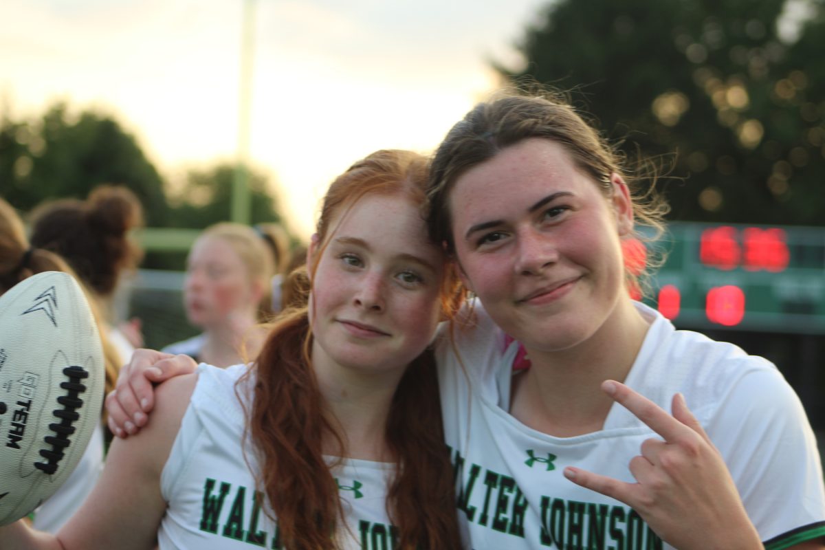 Seniors Ellie Weinstein and Naamiah Corke celebrate their win over the Northwood Gladiators with a final score of 34-0.