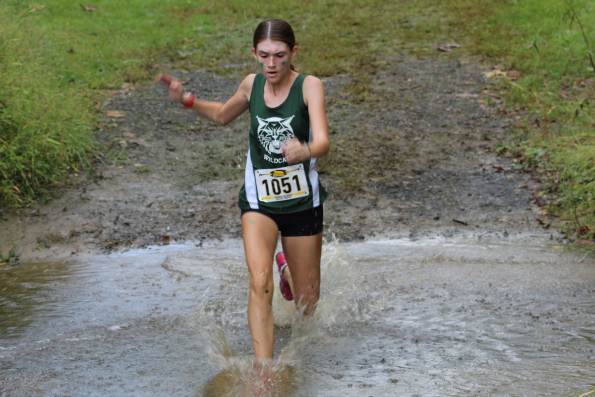 Freshman Sienna Neuman charges through the puddles, keeping up with her pace. Neuman is new to the team and has performed exceedingly well this season so far.