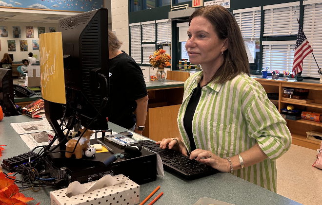 Media Assistant Kathryn Noonan works on the computer during lunchtime. "If you did a chart on how I spend my time on the job, the biggest piece of the pie would be Chromebooks and Chromebook-related issues," Noonan said.