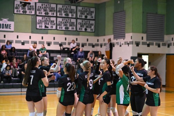 The girls' volleyball team huddles together, discussing their game plan. The Wildcats went on to sweep Whitman in three sets. (Courtesy Tyler Shores via Lifetouch, republished with permission)