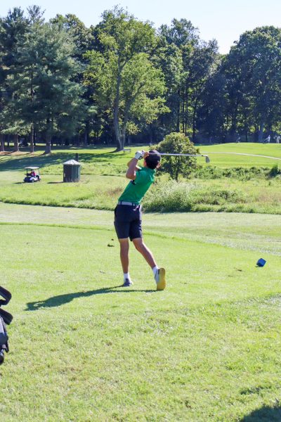 Senior co-captain Connor Kim takes a swing during the golf team's match on Oct. 1. In this match, Kim and several other players were instrumental in breaking a 22-year-old WJ scoring record.