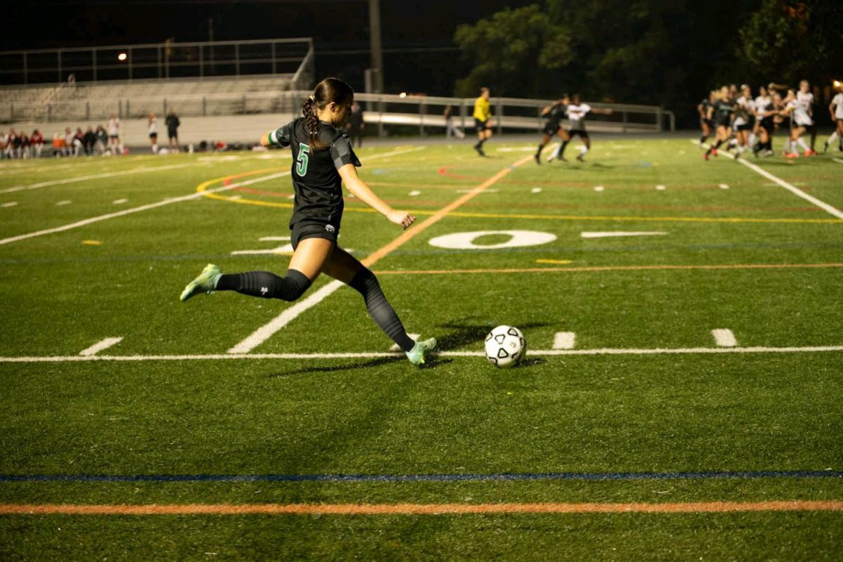 Senior captain Ella Hoban attempts a free kick, which was awarded to the Wildcats after a foul on junior Haley Prindle. The Wildcats took down reigning state finalists Montgomery Blair 2-0 on Monday. (Courtesy Lifetouch)