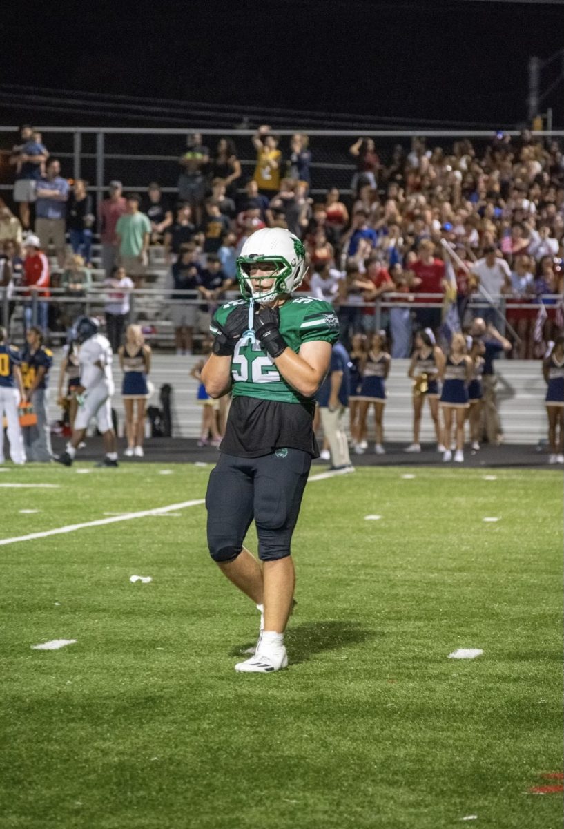 Senior defensive and offensive lineman Jonathan Fisher trots off the field after a big defensive stop. Fisher was named a team captain for the Wildcats this 24-25 season. (Courtesy Spencer Robinson)