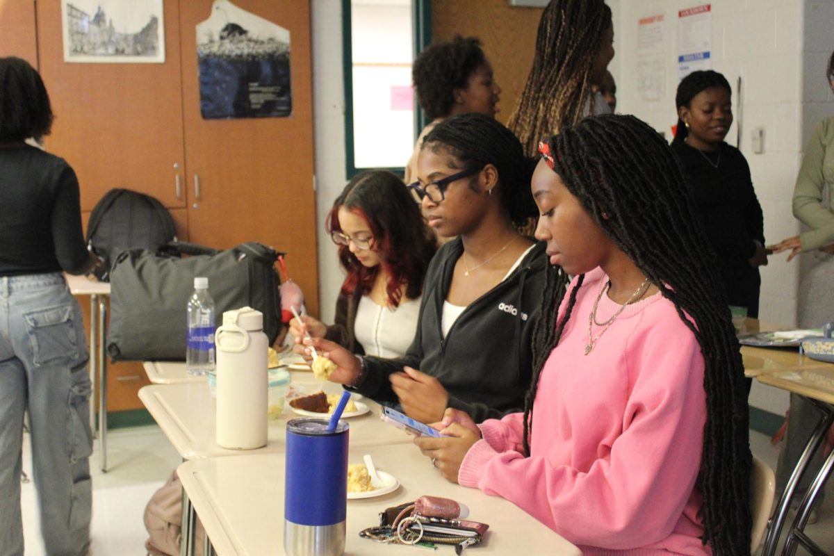 BSU members enjoy home cooked food with their friends. "I like coming here because it's a fun community," senior Lenny Yuhi said.