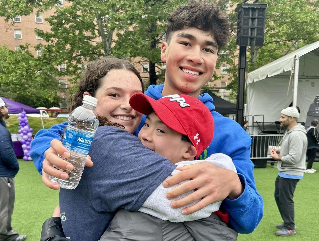 Club president Sadie Morgenstern and treasurer Brady Chan embrace in a hug with his younger brother, Ryder, at the annual friendship walk last year. “The walk is a fun way to interact with people from other schools and everyone seems to really enjoy it,” Chan said.