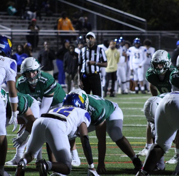 Junior quarterback Jake Forburger takes the snap from junior center Andrew Corrado during the game against Laurel. Forburger consistently drove the ball down the field, contributing to a 40-13 win.