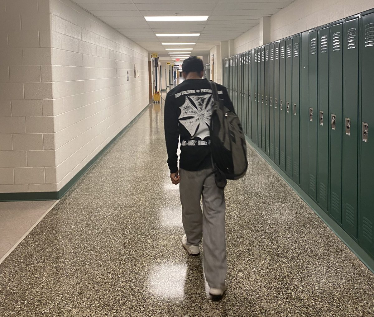 A student tiredly walks down a hallway after a school day. Many students feel drained after a day of school, but is WJ the problem?