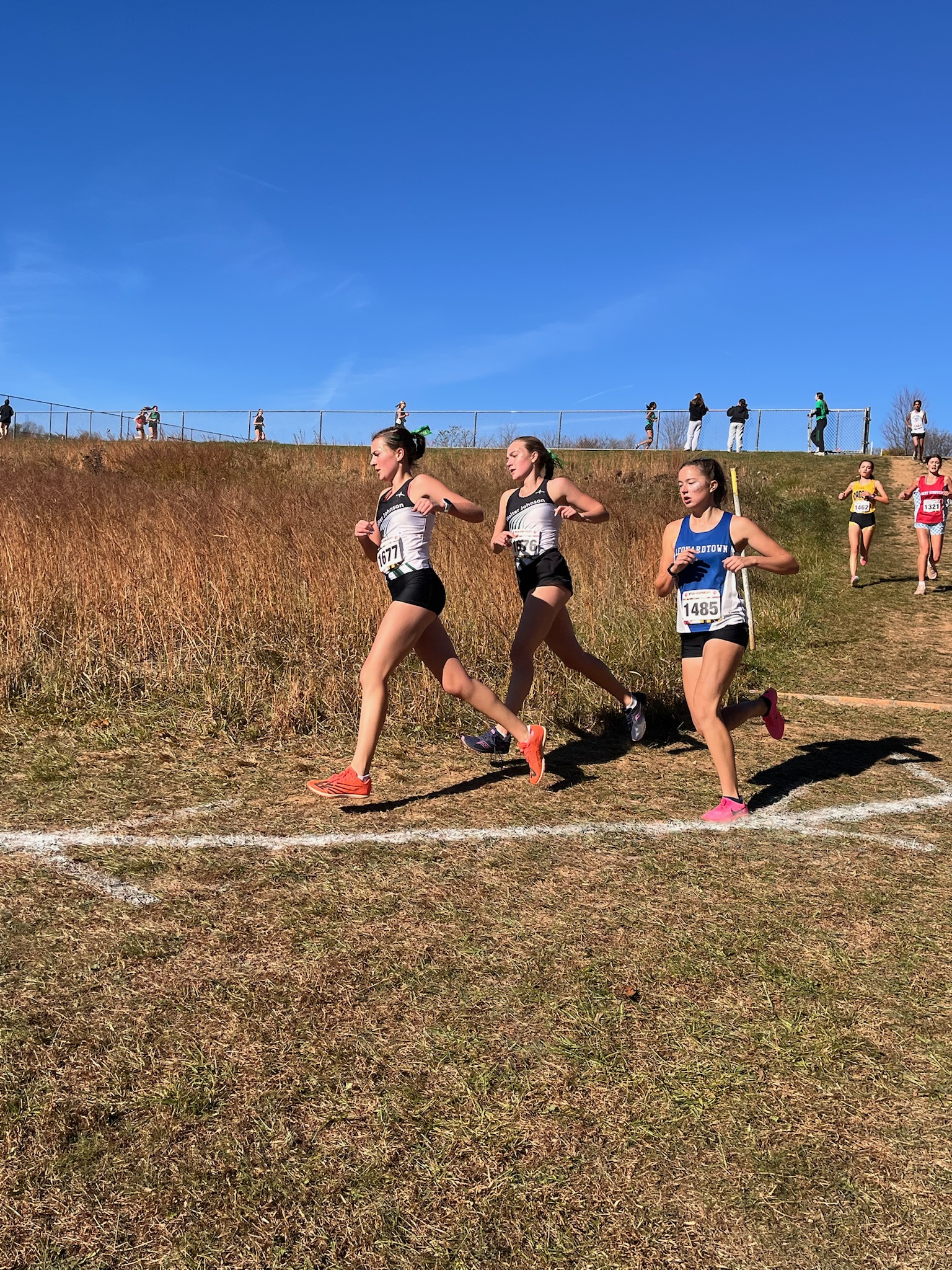 Junior Annie Linkie and senior Anna Kotek run down one of the many hills of the states course. "The race was really crowded at the start and it was difficult to find a spot where I could keep my pace," Linkie said. "Luckily, I was able to run with some of my teammates which always helps with the mental difficulty during the race."