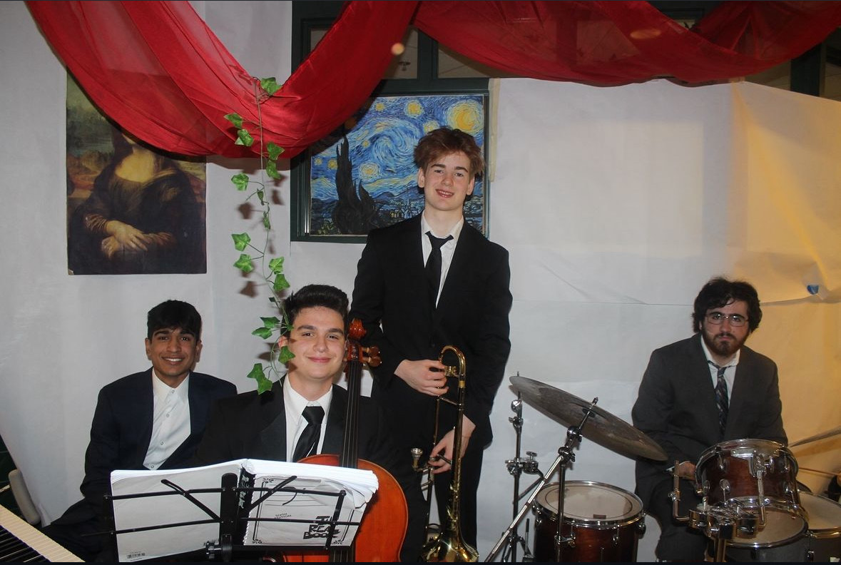 Vijay Kannen (11), Bertie Bennett (11), Theo Hansen (11) and Idan Tzioni (12) pose for a photo at the Junior's Homecoming Hallway. Their performance caused a traffic jam as students stopped to listen to the music. (Courtesy Paul Gomes)