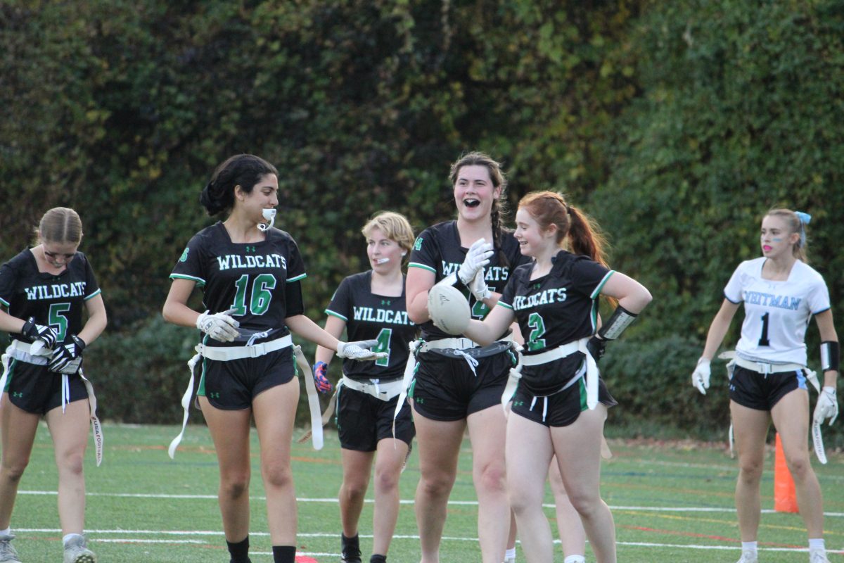 Seniors Ellie Weinstein, Rhea Noumair, Naamiah Corke, and Natalie Annulis celebrate Weinstein's first touchdown of the game.