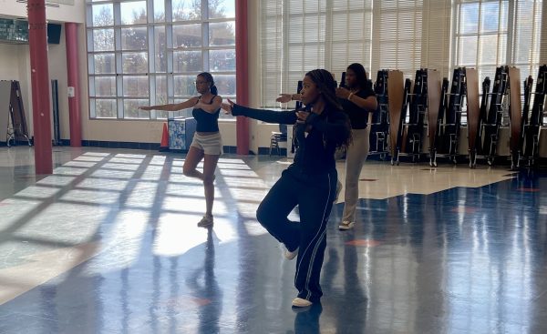 Senior Mwape Sokoni (middle), junior Daniella Ngah (right) and senior Michelle Lett (left) practice a routine in the cafeteria. Step Team practices diligently, performing the routine until the entire group catches on.