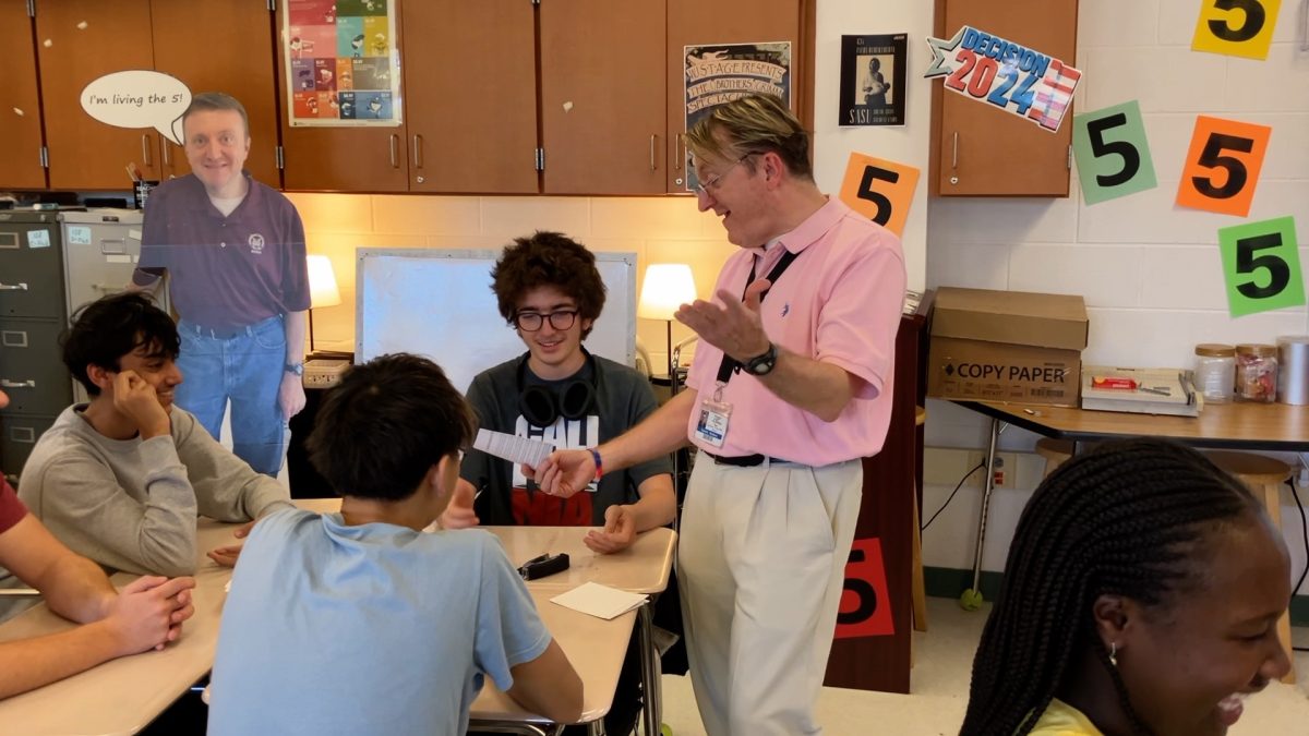 Social studies teacher Timothy Rodman holds a production factory simulation in his AP Microeconomics class. "Students remember running for class president or the mock congress or the production factory much more so than learning topics like circular flow," Rodman said. "[The simulations make learning] very tangible and real and then students down the road are able to use it."