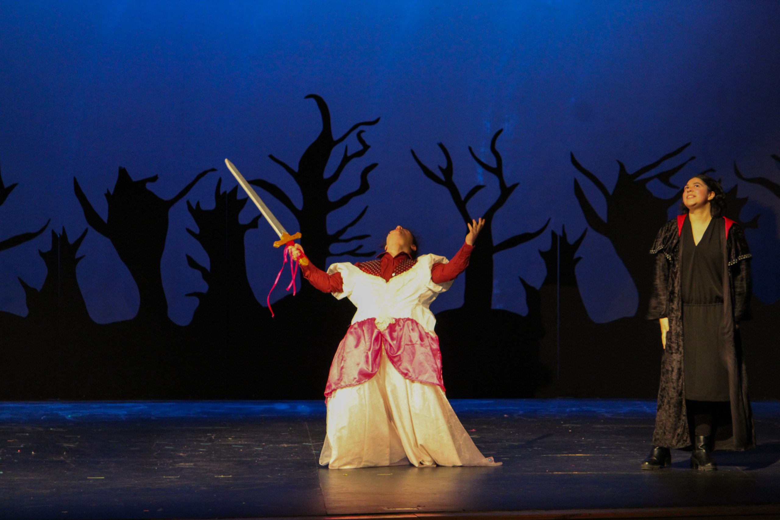 Sophomore Lior Sterling throws back his head and cackles, brandishing a sword and wearing a dress on top of his suit. He proceeded to stab Witch 2, played by Allisandra Martinez Palma, with enthusiasm.