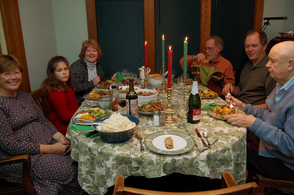 A family happily enjoys a holiday meal together, with all the members seemingly enjoying themselves except for the only child in the image. We all know what she's going through and wish we had something-anything to talk to our extended family about. 