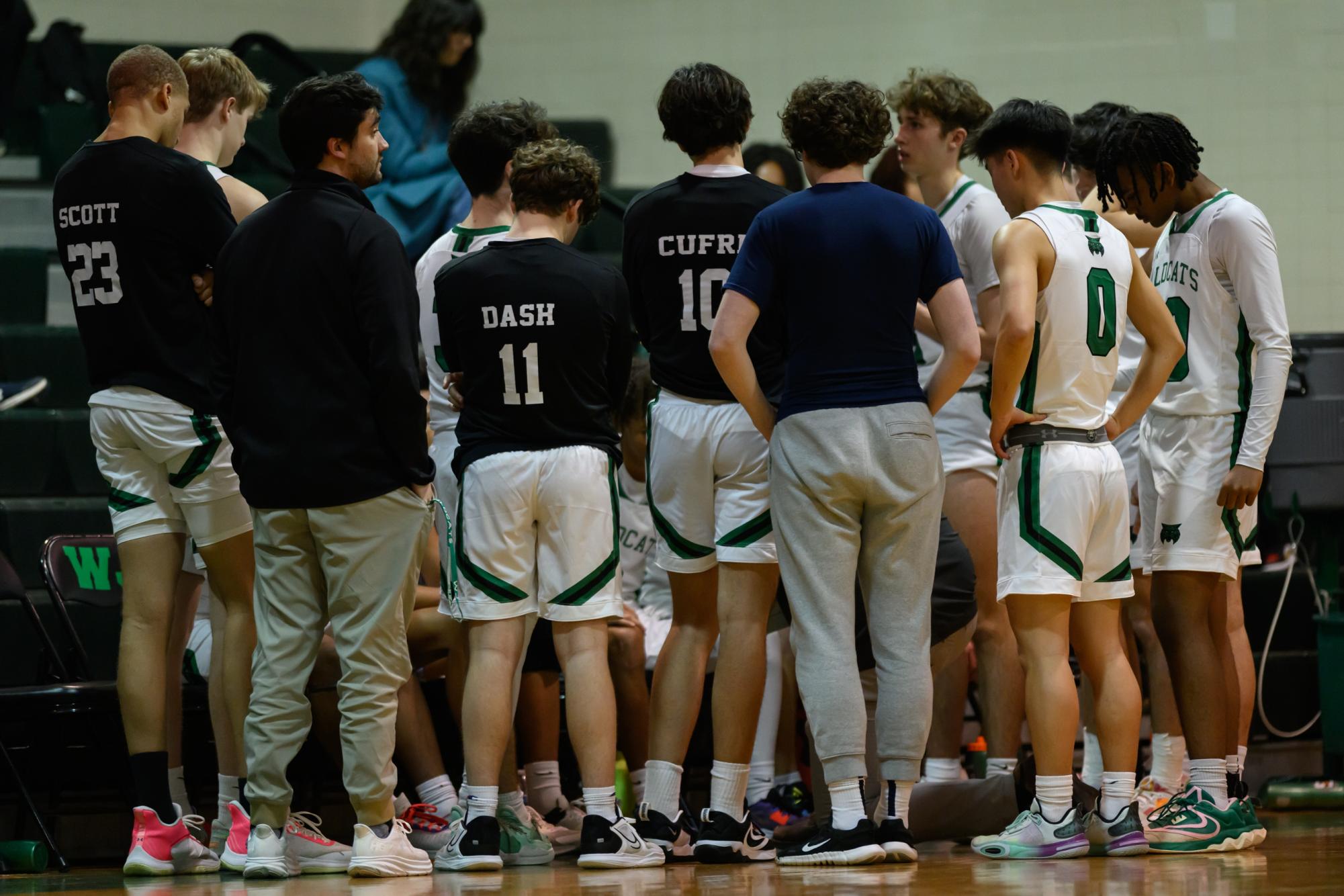 The boys basketball team in a huddle last year during a timeout. Leadership is a key part to any team's success, as younger players look up to players who have been on the team before.