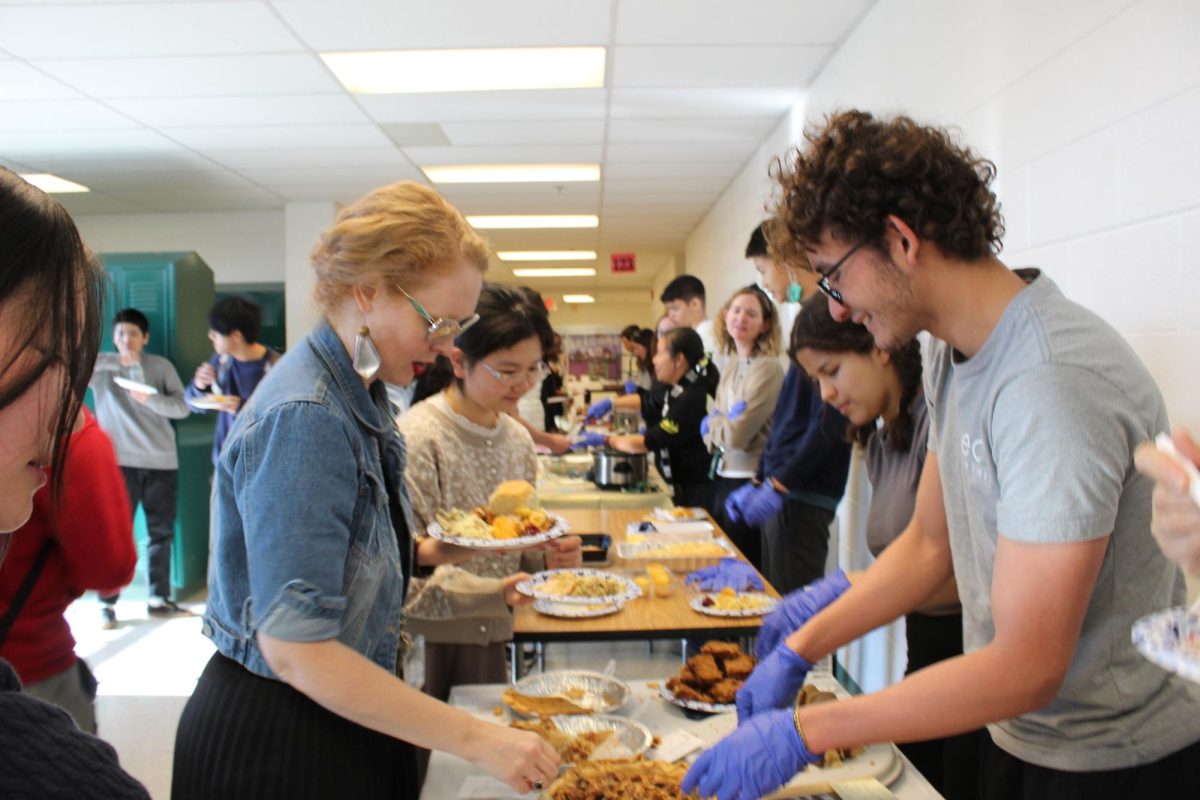 Senior Jacobo Gutierrez serves food during the ESOL Thanksgiving Luncheon on Nov. 25. Gutierrez was one of many volunteers who worked to create a welcoming environment for new international students.