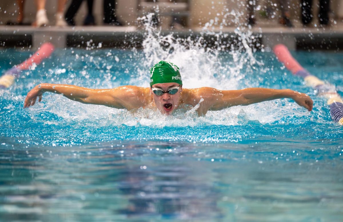 Senior J.D Peppelman swims butterfly in the meet against Whitman. WJ boys had a few strong individual performances but were missing key swimmers. "When we have our full team back, we'll win," junior Owen Friedman said. (Courtesy Tom Murphy)